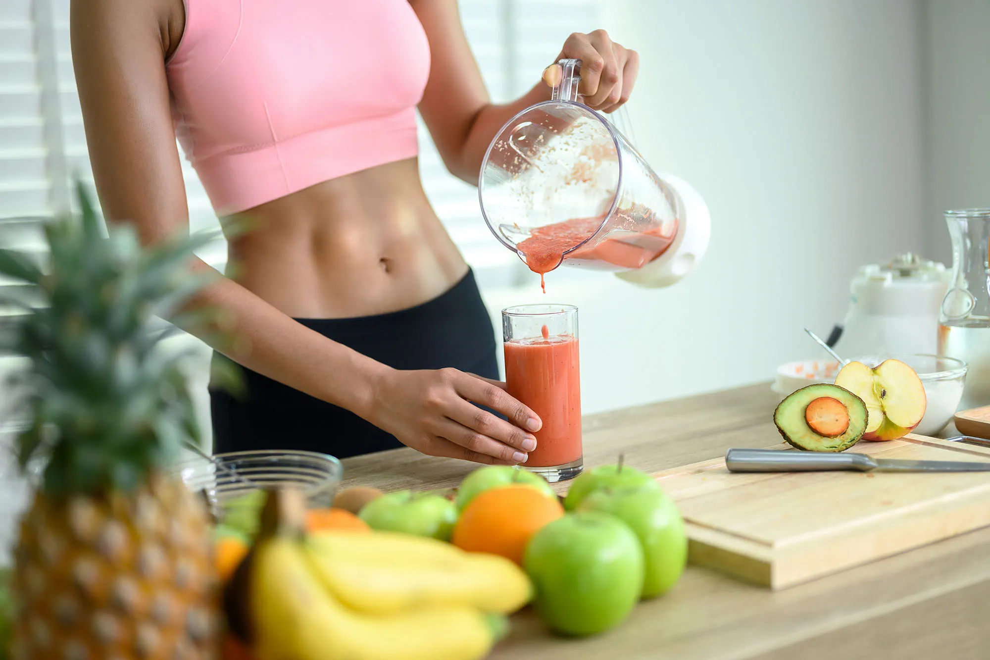 hand of woman pouring smooties to glass