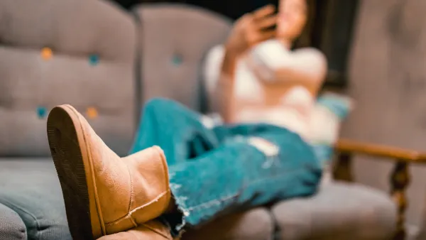 Beautiful young woman using phone in a downtown café
