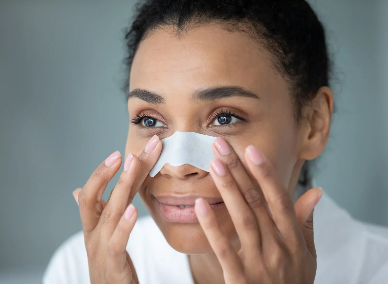 Woman applying a nose strip