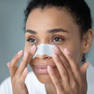 Woman applying a nose strip