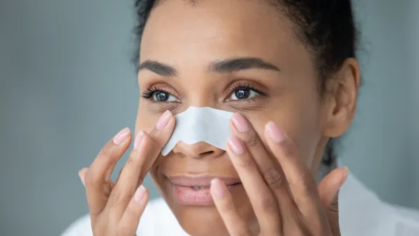 Woman applying a nose strip