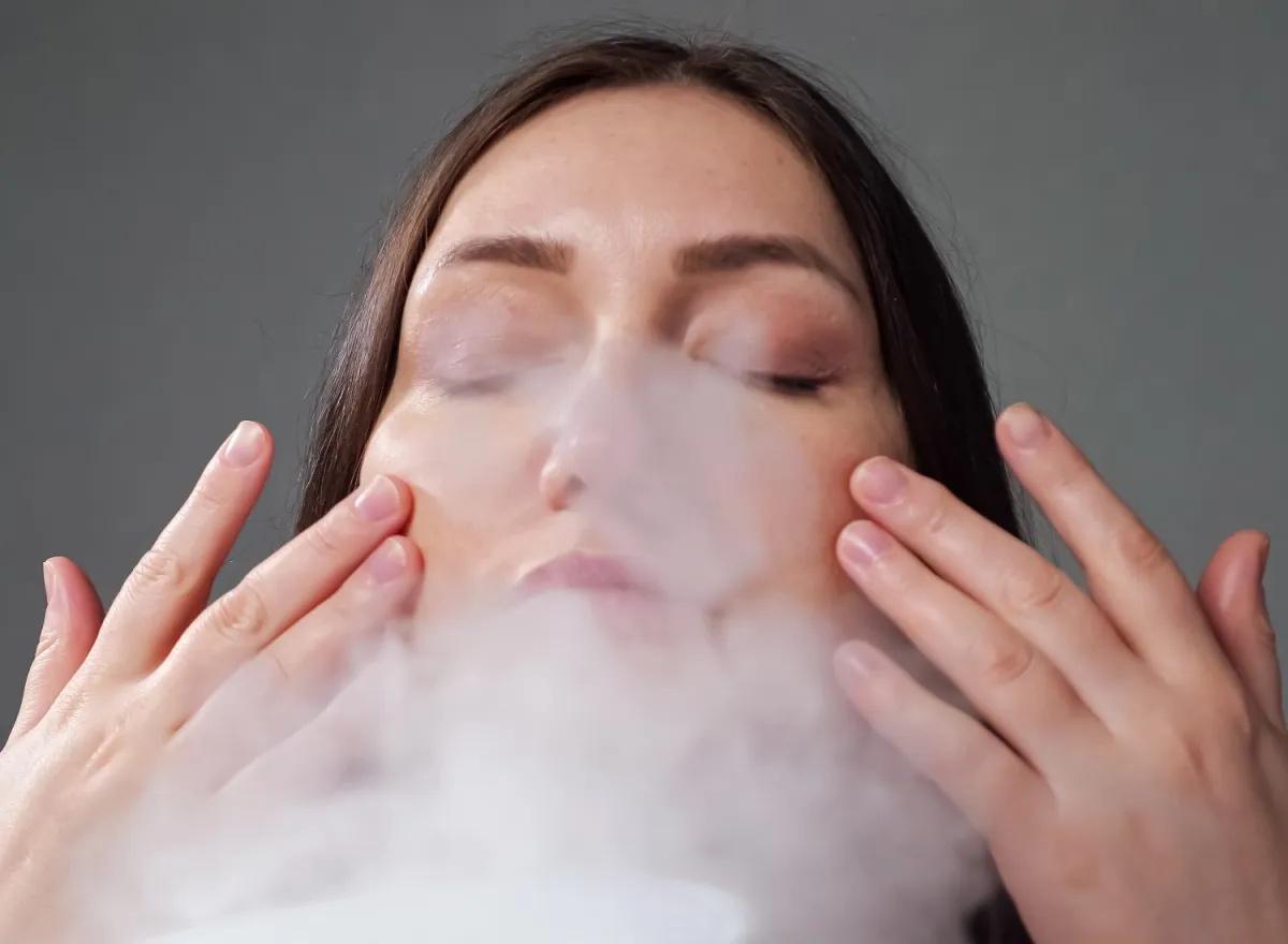 Woman using a face steamer