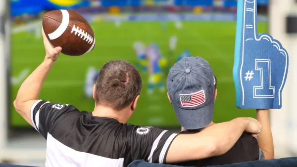 Father and son watching football