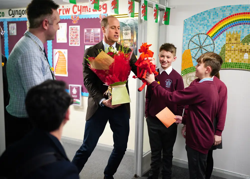 Prince William Receives Gifts for His Children, Flowers for Wife From Students at Welsh School