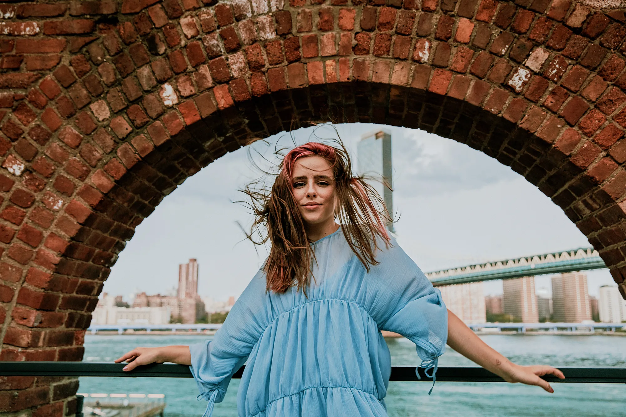 Portrait of young woman standing in windy weather.