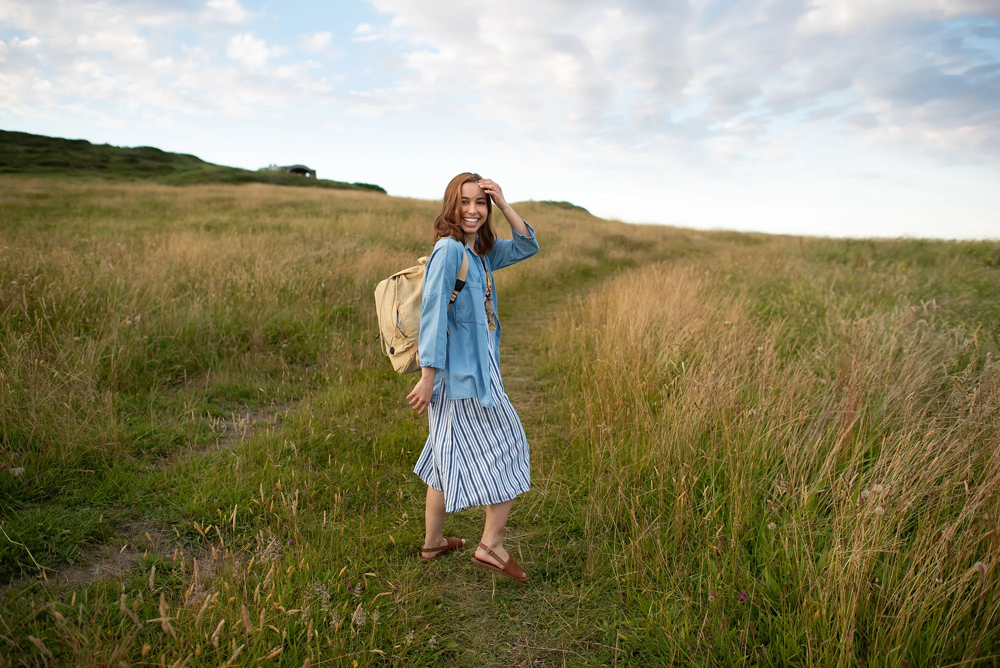 a young woman traveling outdoors carrying a bag in the area de Cantabria in Northern Spain.