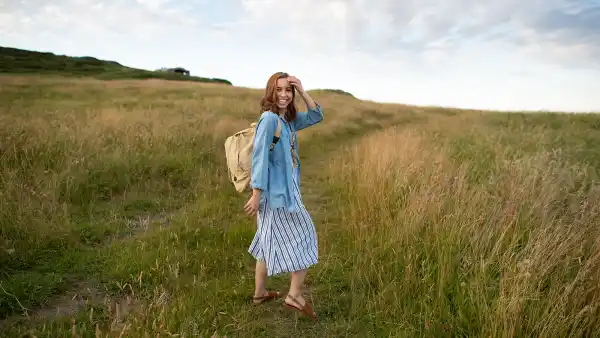 a young woman traveling outdoors carrying a bag in the area de Cantabria in Northern Spain.