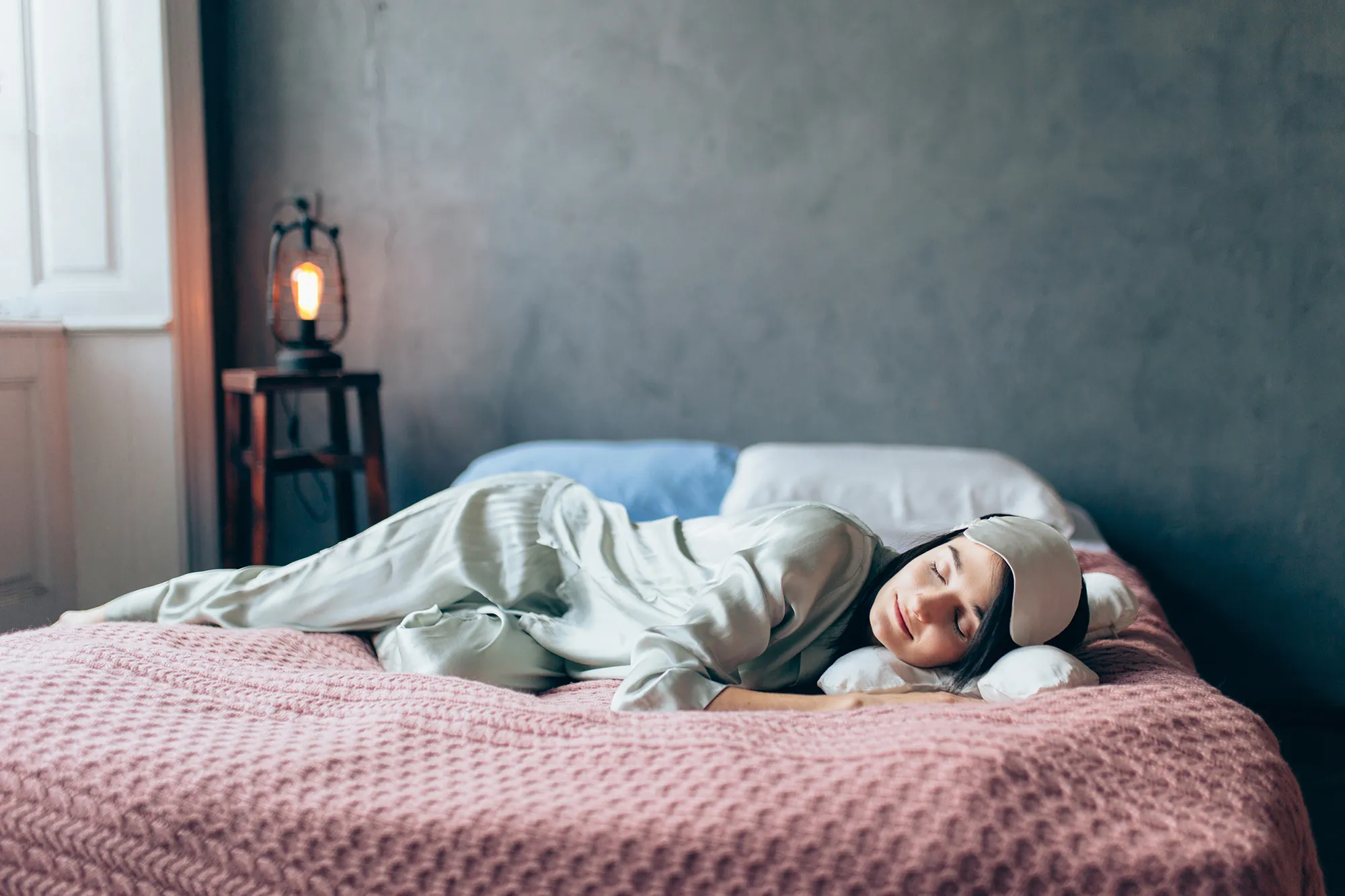 Portrait of woman resting in cozy bedroom.