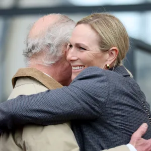 Excited Zara Tindall hugs King Charles during reunion