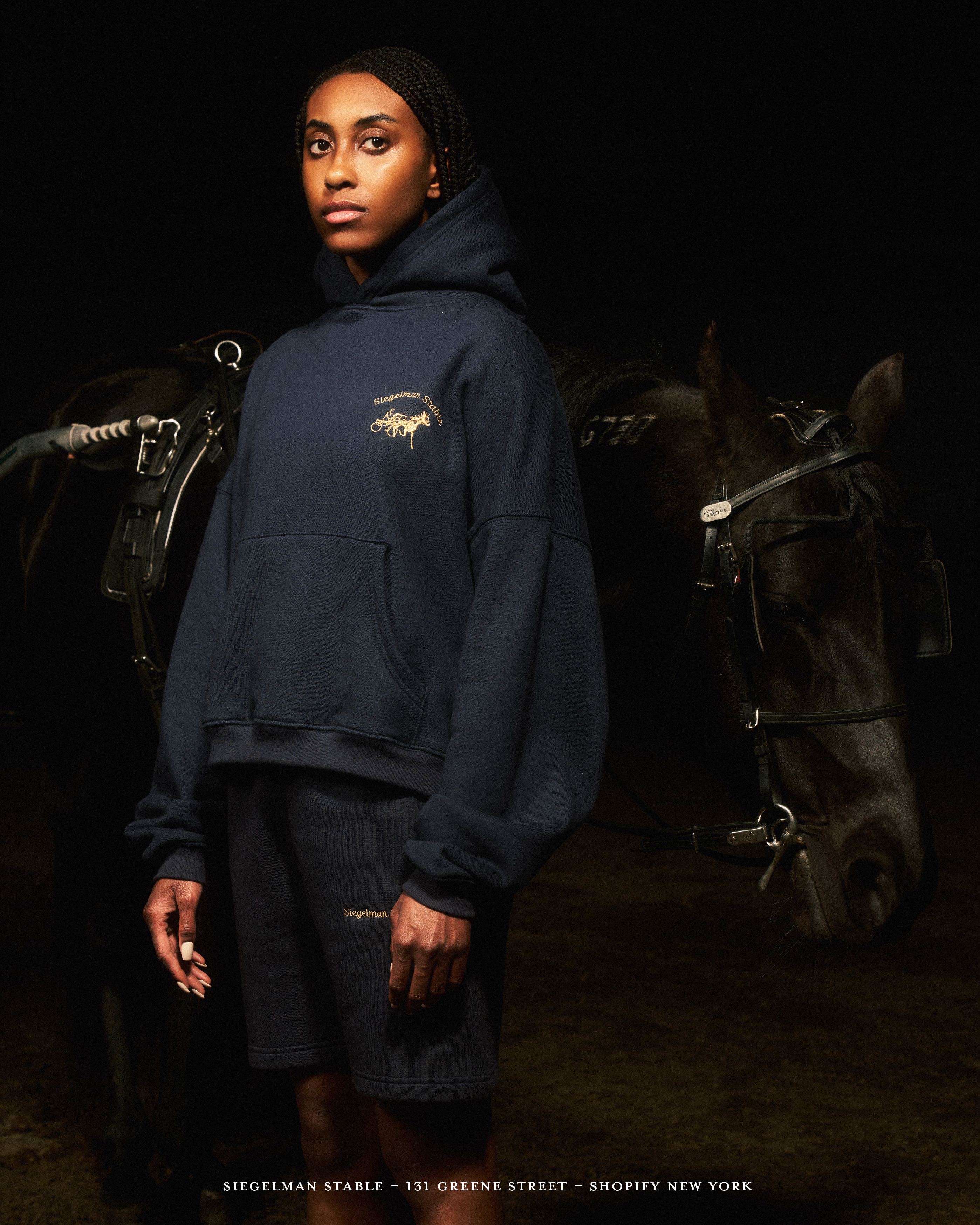 Woman in Siegelman Stable sweatshirt with hourse