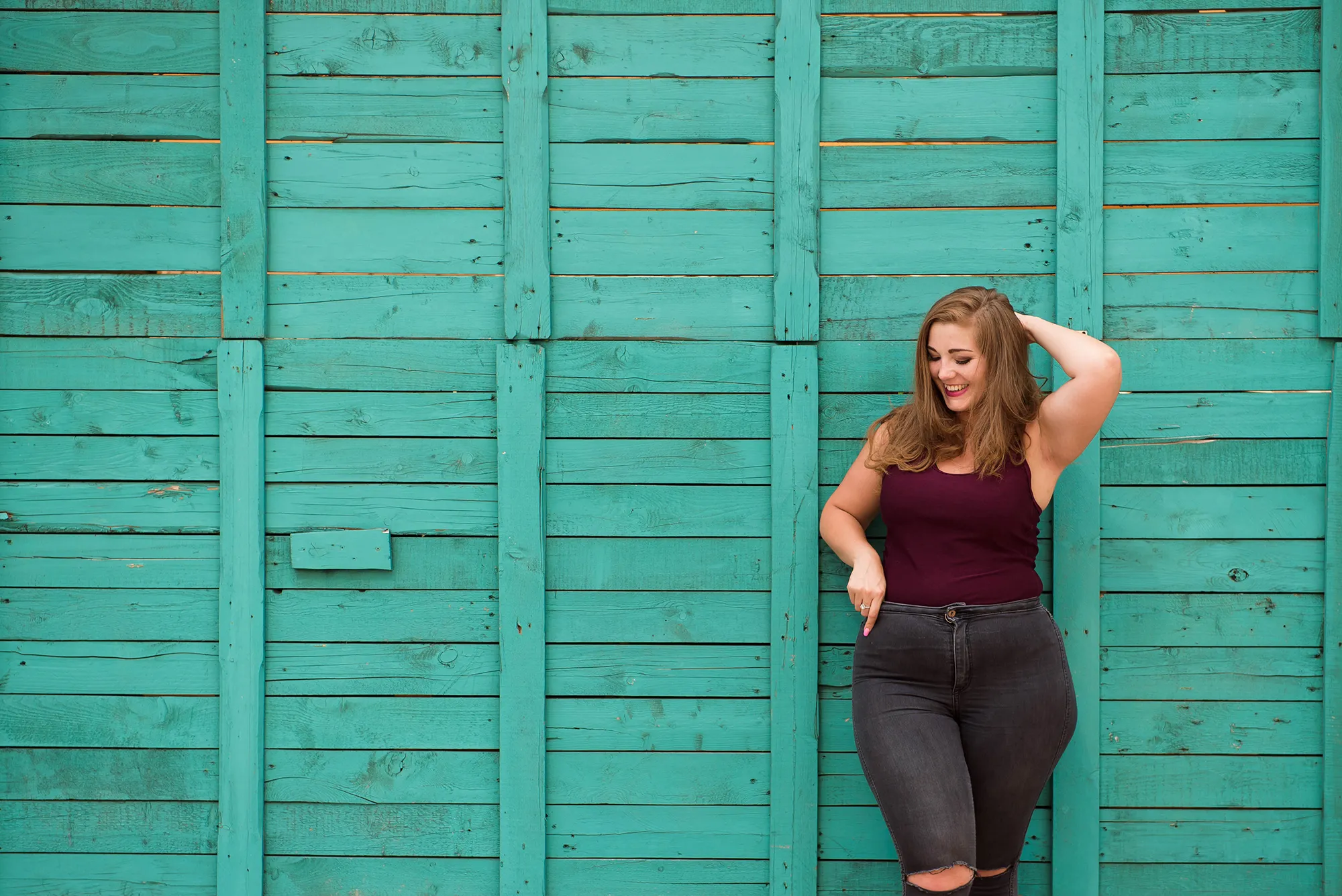 blond girl model plus size on the background of a green wall