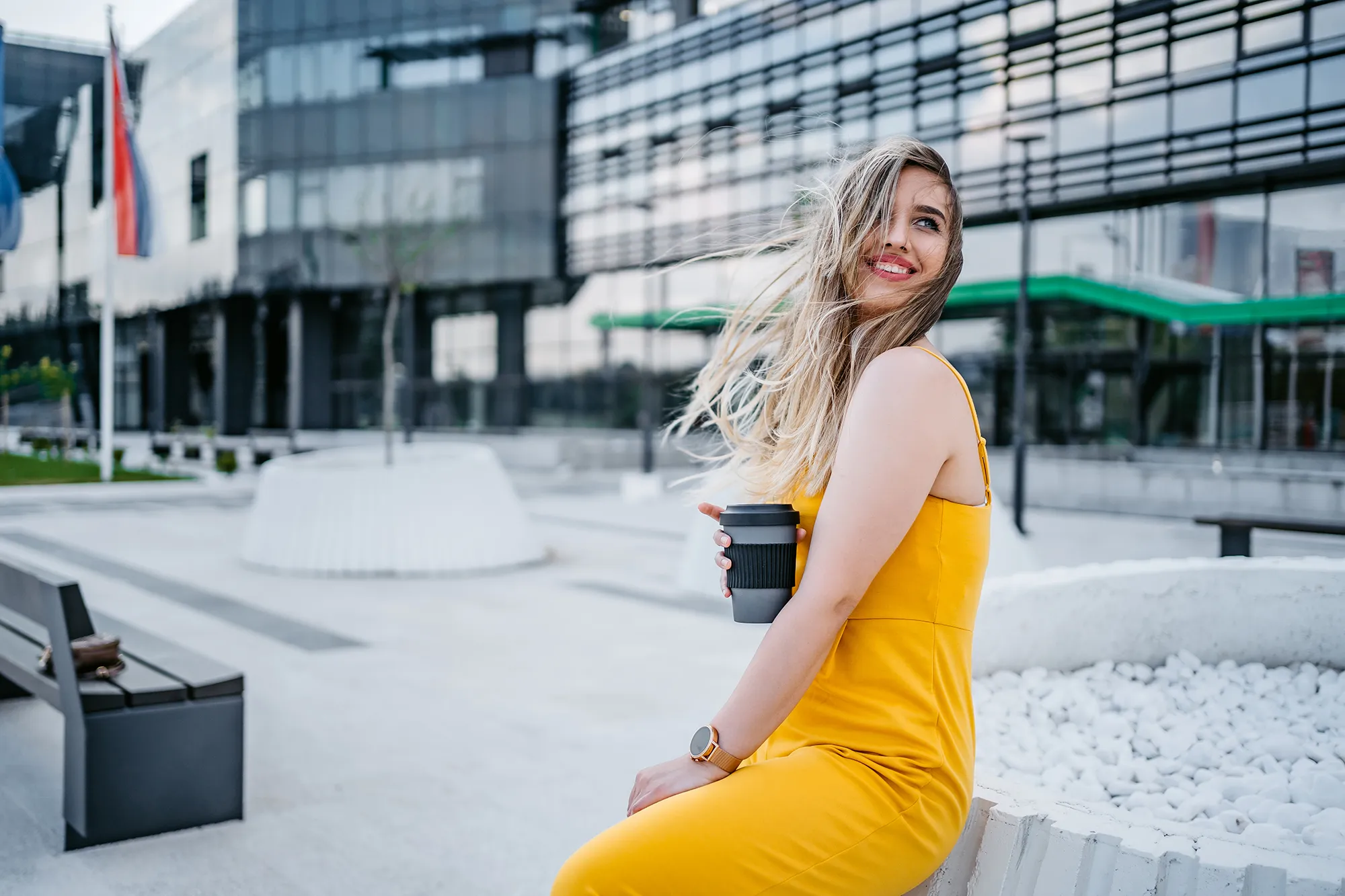 Beautiful young woman drinking coffee in a downtown district.