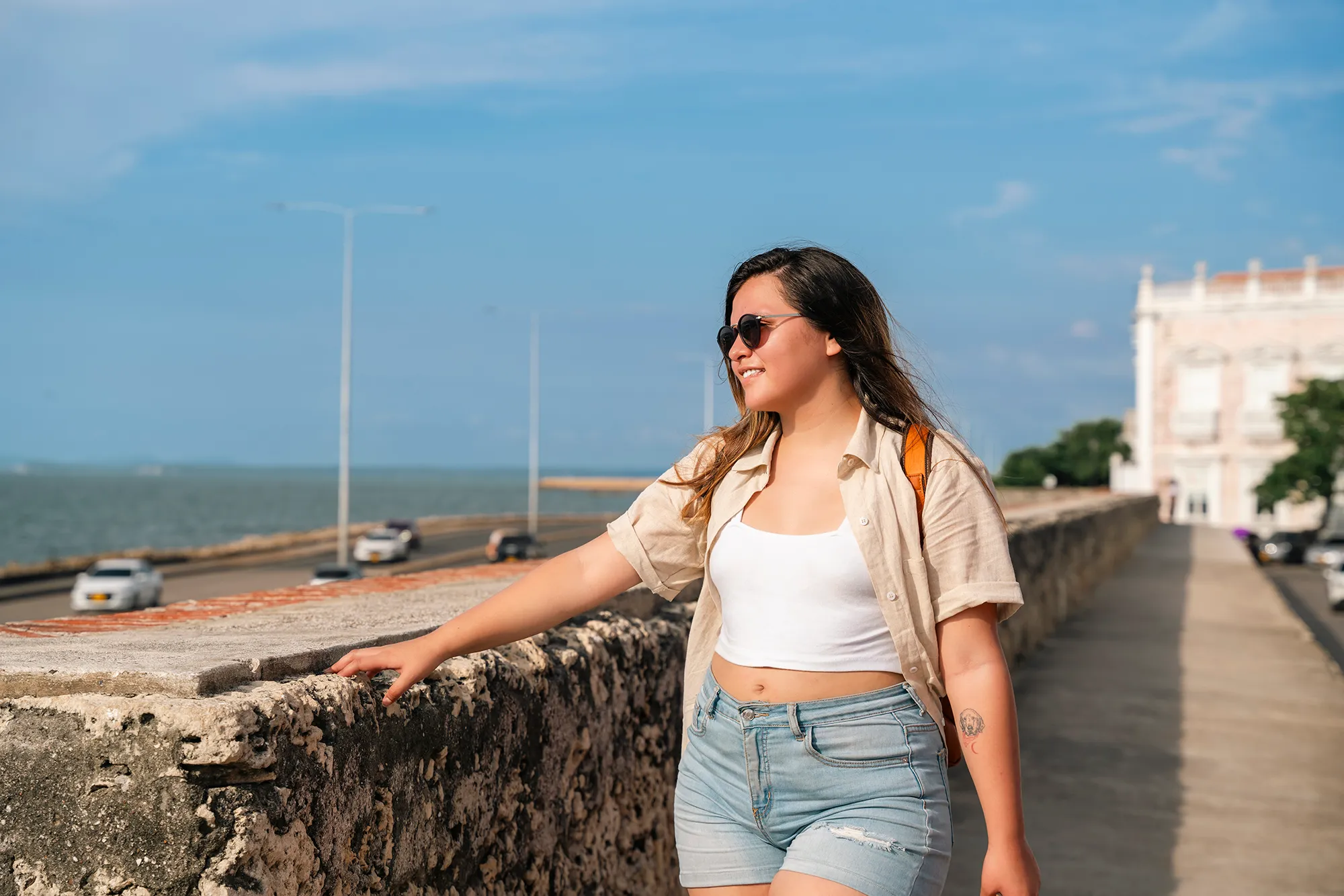 A Traveling Woman in a leather backpack explores the tropical and wonderful Cartagena