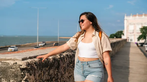 A Traveling Woman in a leather backpack explores the tropical and wonderful Cartagena