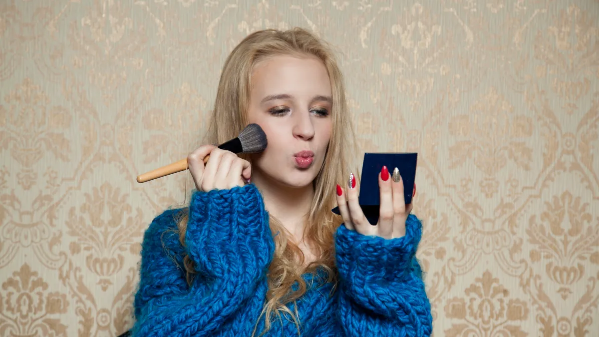 Woman applying makeup