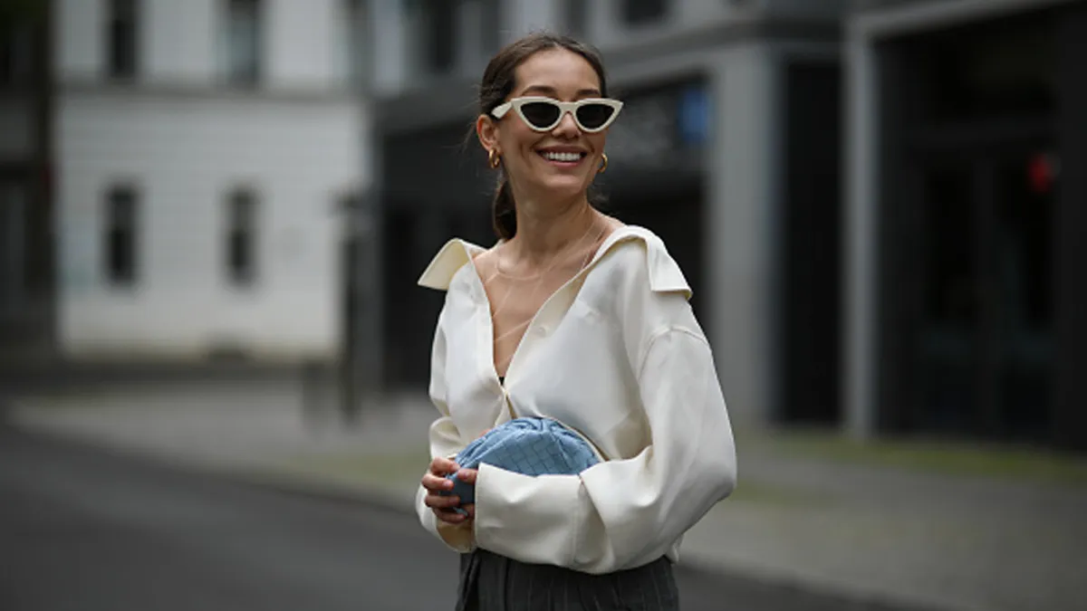 Woman wearing button up top and trousers