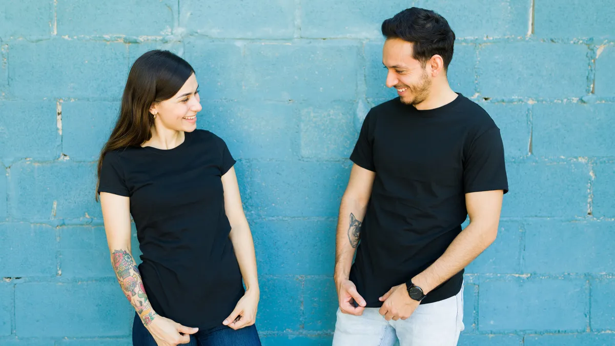 Matching t shirts. Young couple feeling happy after they had t-shirts made with the same designs