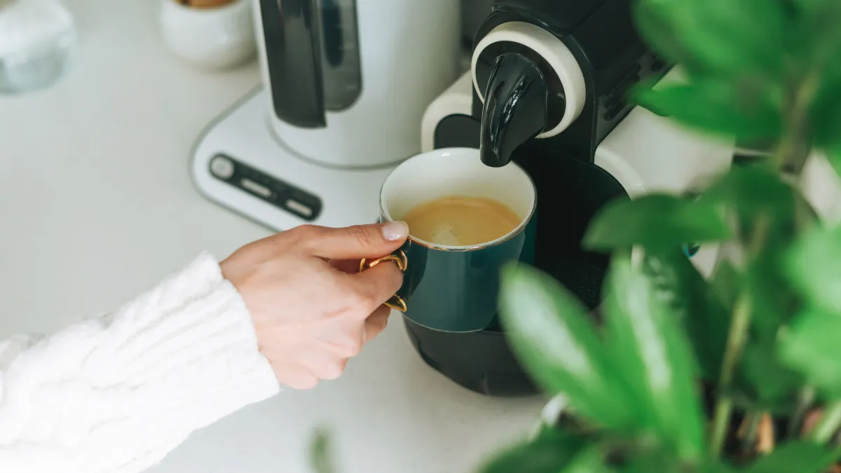 Pouring coffee from machine