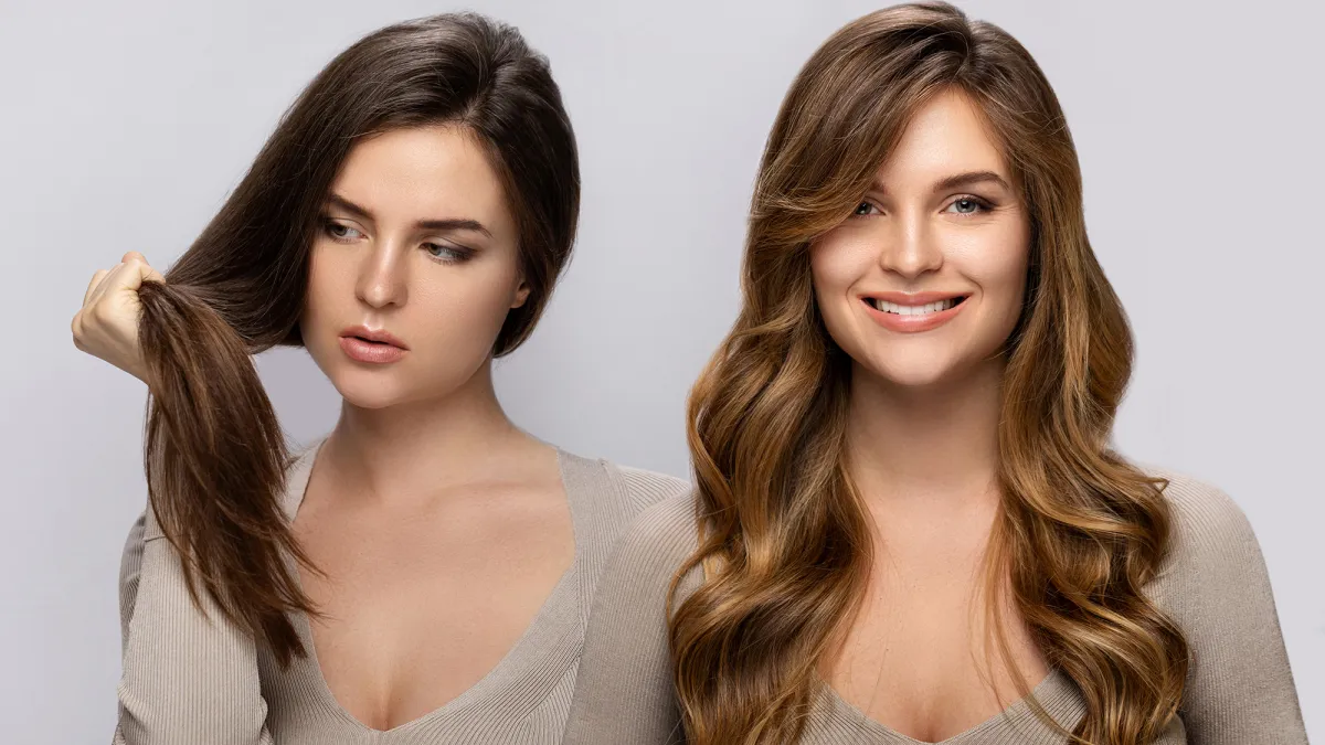 Result of makeover. Young woman happy with her beautiful hair after dyeing and styling in a professional salon.