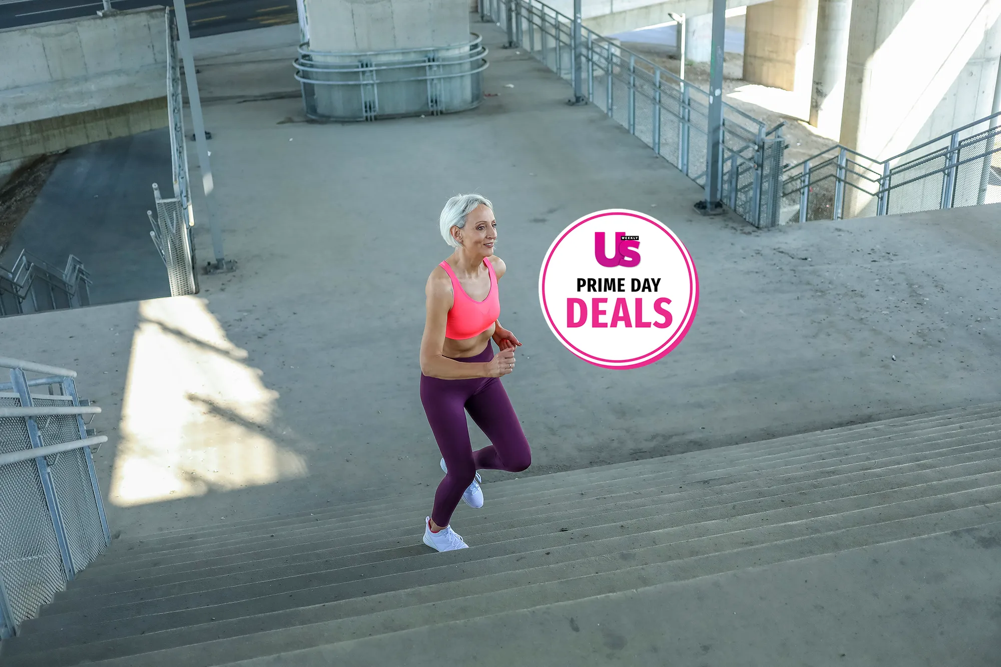 Senior woman with grey hair in sports clothes exercising outside while listening to music. Beautiful mature woman jogging.