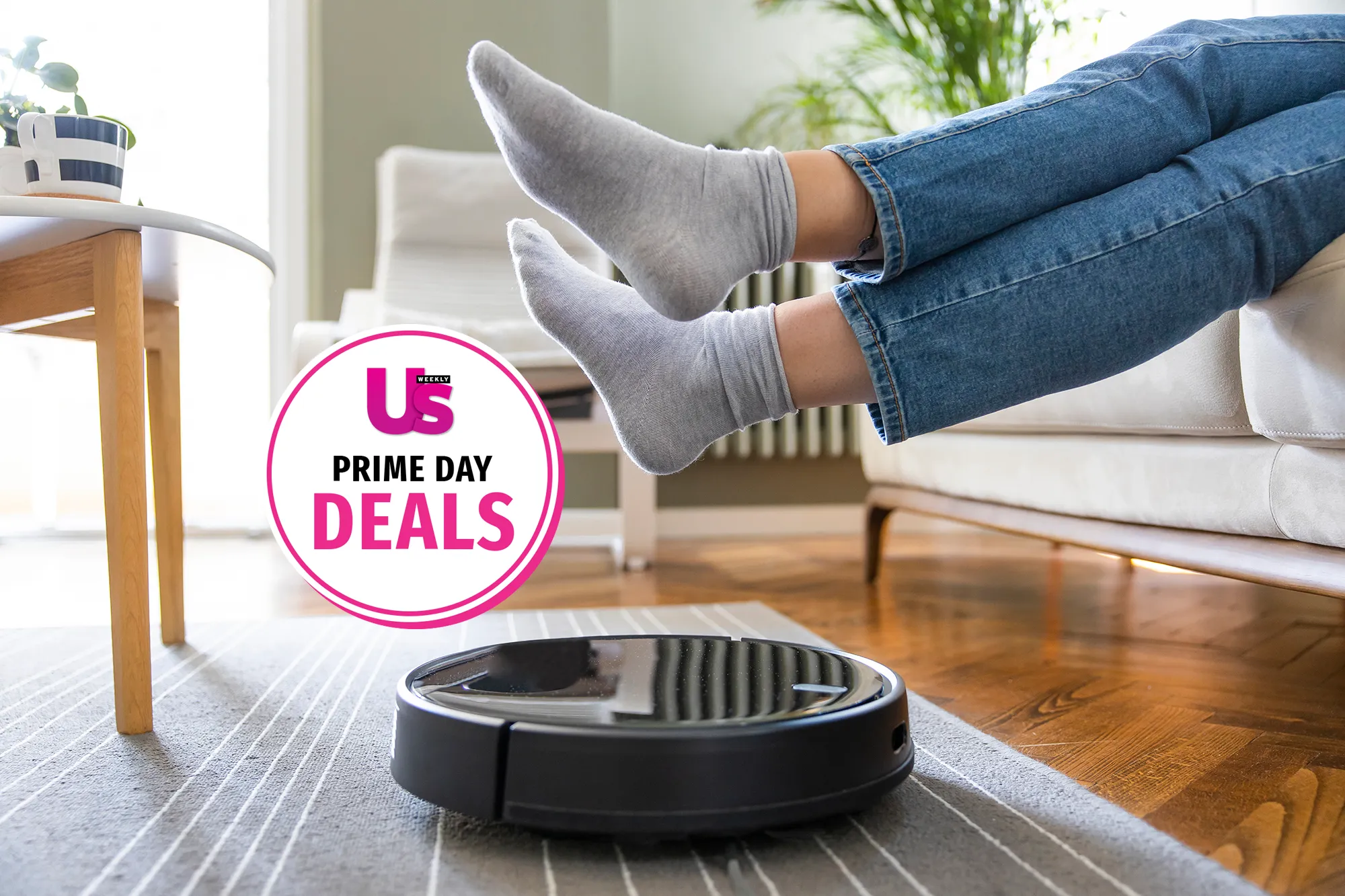 Young woman lift up the feet for letting robotic vacuum cleaner pass though