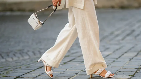 woman wearing flowy beige pants