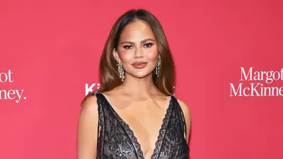 Chrissy Teigen Reveals Surgical Scar in Low Cut Dress Boobies Out