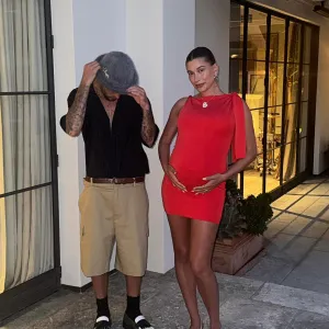 Pregnant Hailey Bieber Wows in Red Frock While Cradling Baby Bump With Justin Bieber