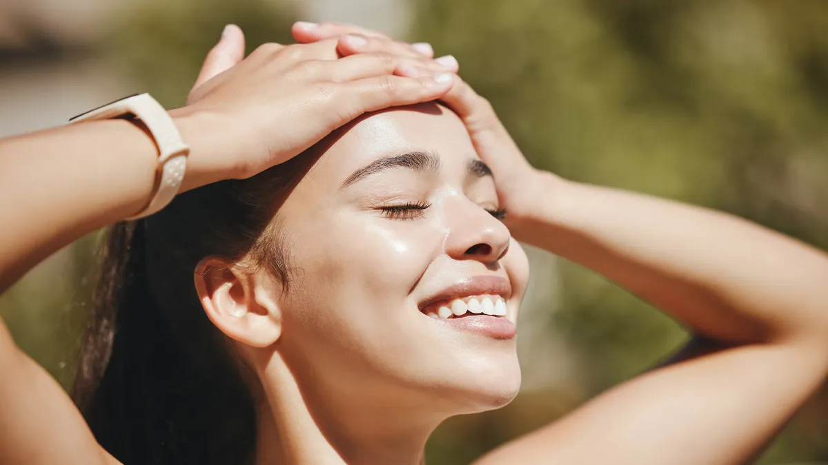 Face, relax and happy woman in sunshine, outdoor fresh air and peaceful break for mental health, wellness and body. Summer, happiness and smile latino girl relax in nature, park rest and calm freedom