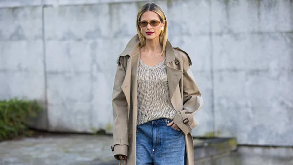 woman wearing beige sweater, jeans and trench coat