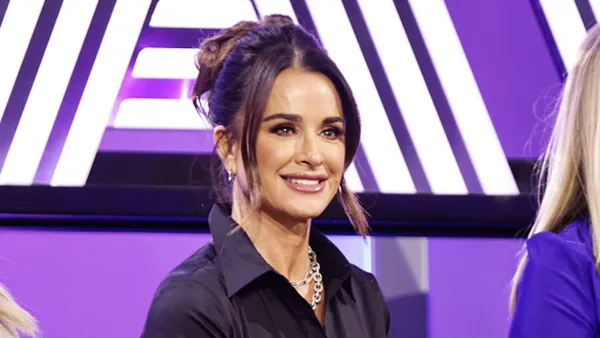 Kyle Richards in black top on stage
