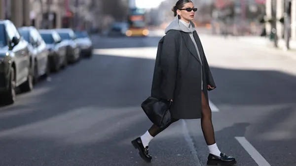 woman wearing coat and loafers