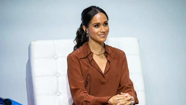 Meghan Markle wearing brown button down top
