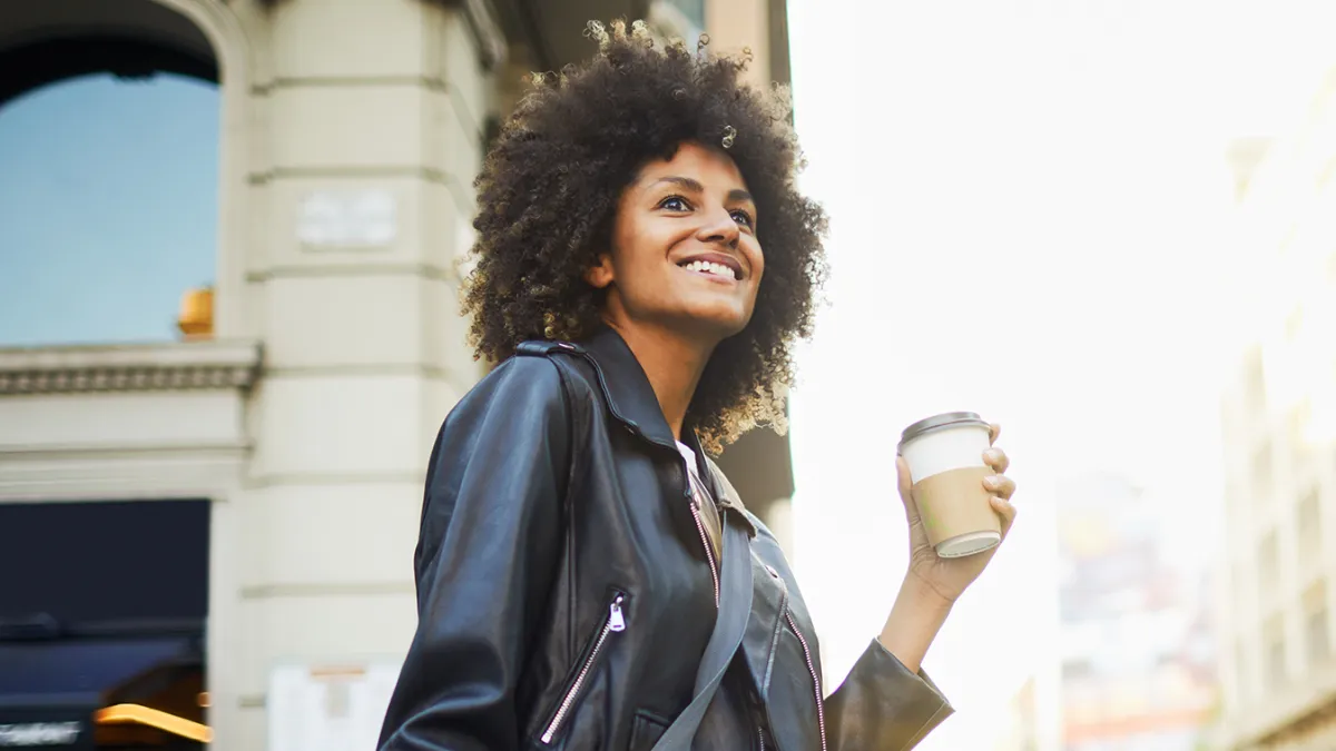 Young hipster woman in the streets of Barcelona commuting.