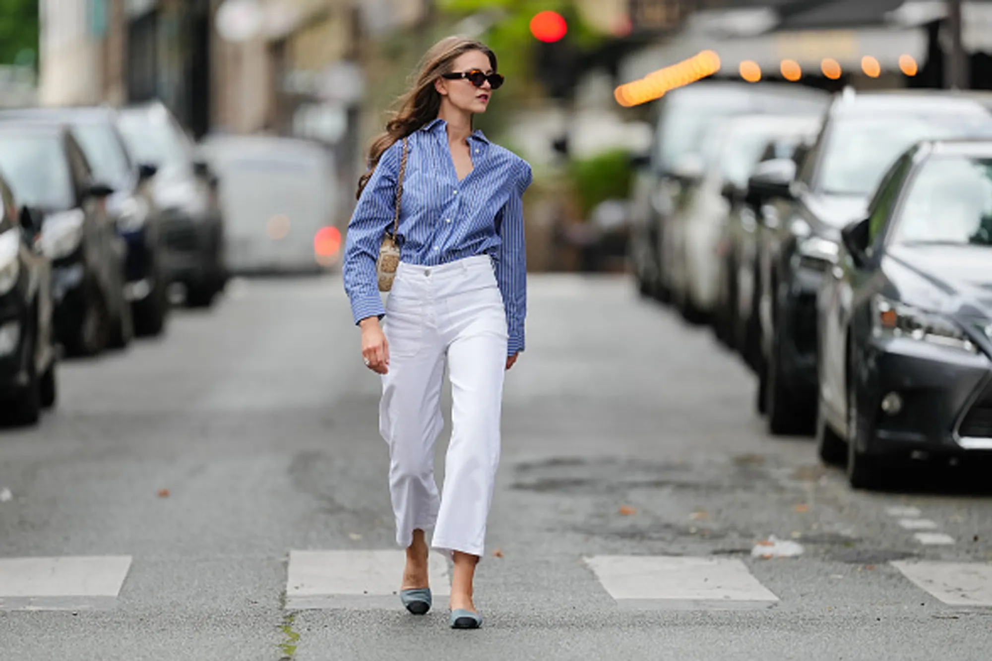 woman wearing white pants and blue button up top