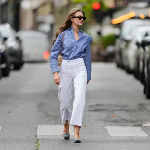 woman wearing white pants and blue button up top