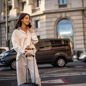woman wearing white blouse and pants in city