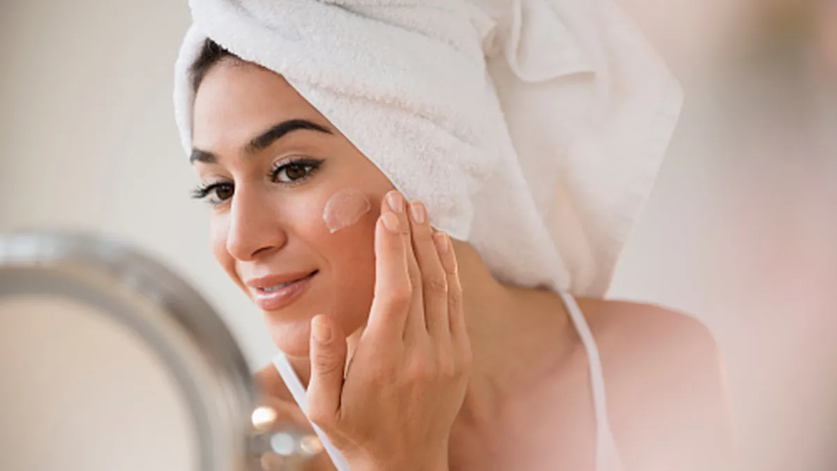 woman putting on skincare