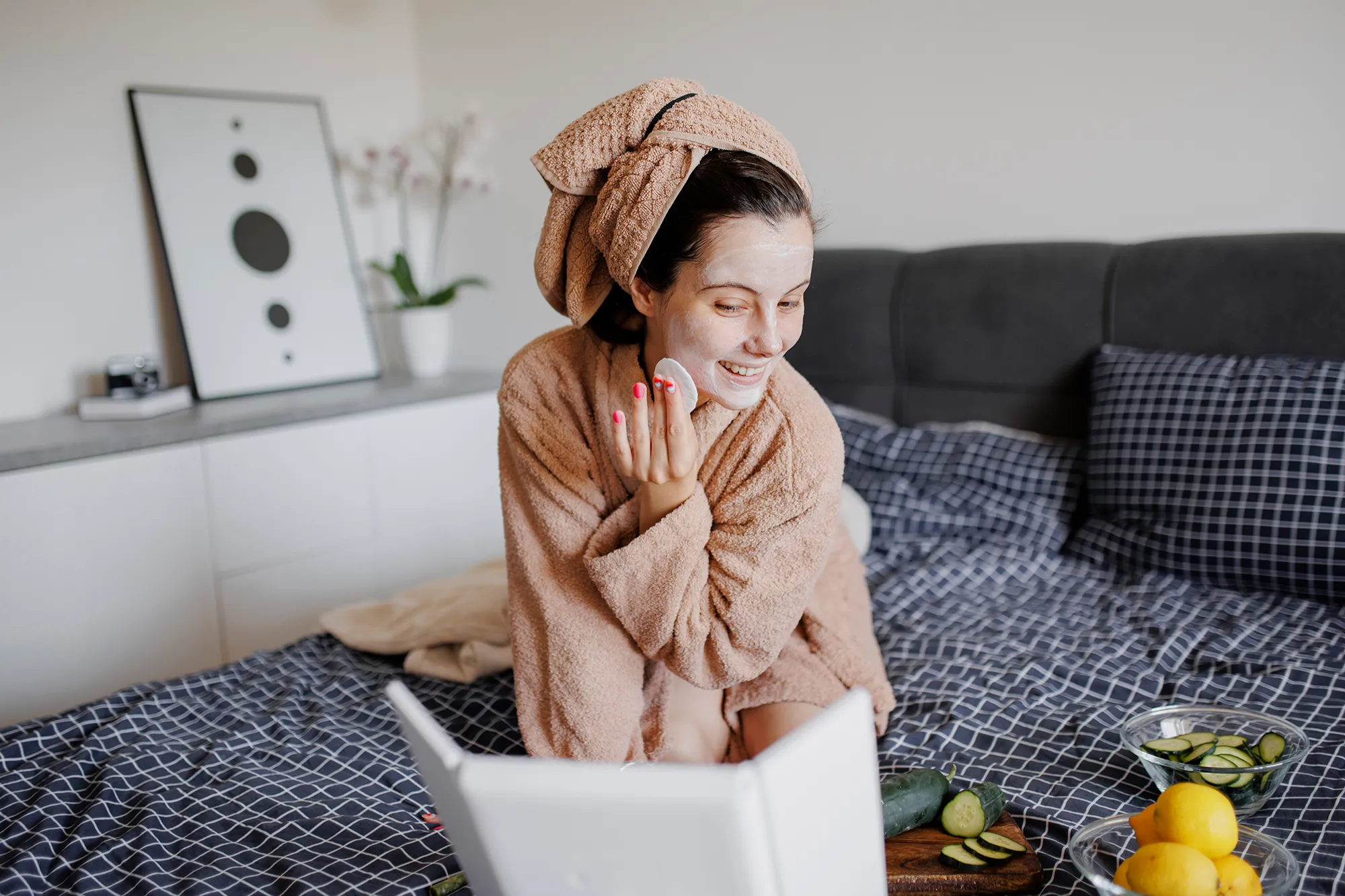 Portrait of woman having skin care routine in bed