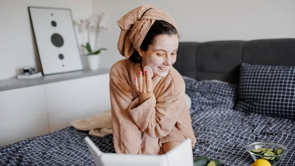 Portrait of woman having skin care routine in bed