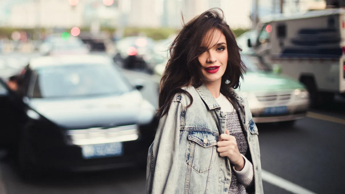 Young beautiful woman standing on the street