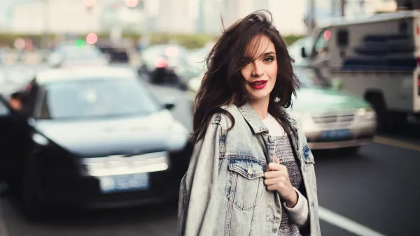 Young beautiful woman standing on the street