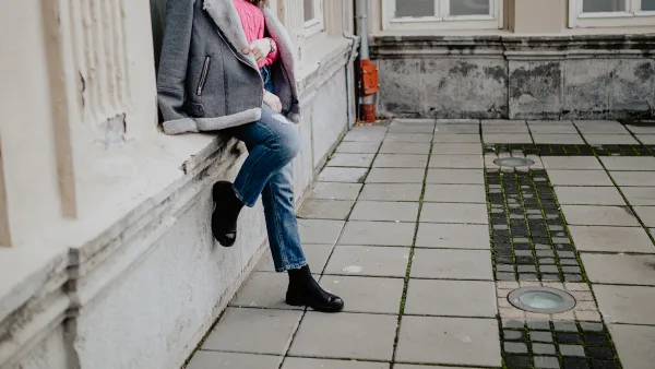 Beautiful young fashionable woman relaxing and enjoying a lovely autumn day in the city street