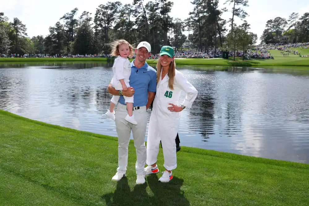 AUGUSTA, GEORGIA - APRIL 05: Rory McIlroy of Northern Ireland poses for a photo with his wife, Erica Stoll and daughter Poppy McIlroy during the Par 3 contest prior to the 2023 Masters Tournament at Augusta National Golf Club on April 05, 2023 in Augusta, Georgia. (Photo by Andrew Redington/Getty Images)