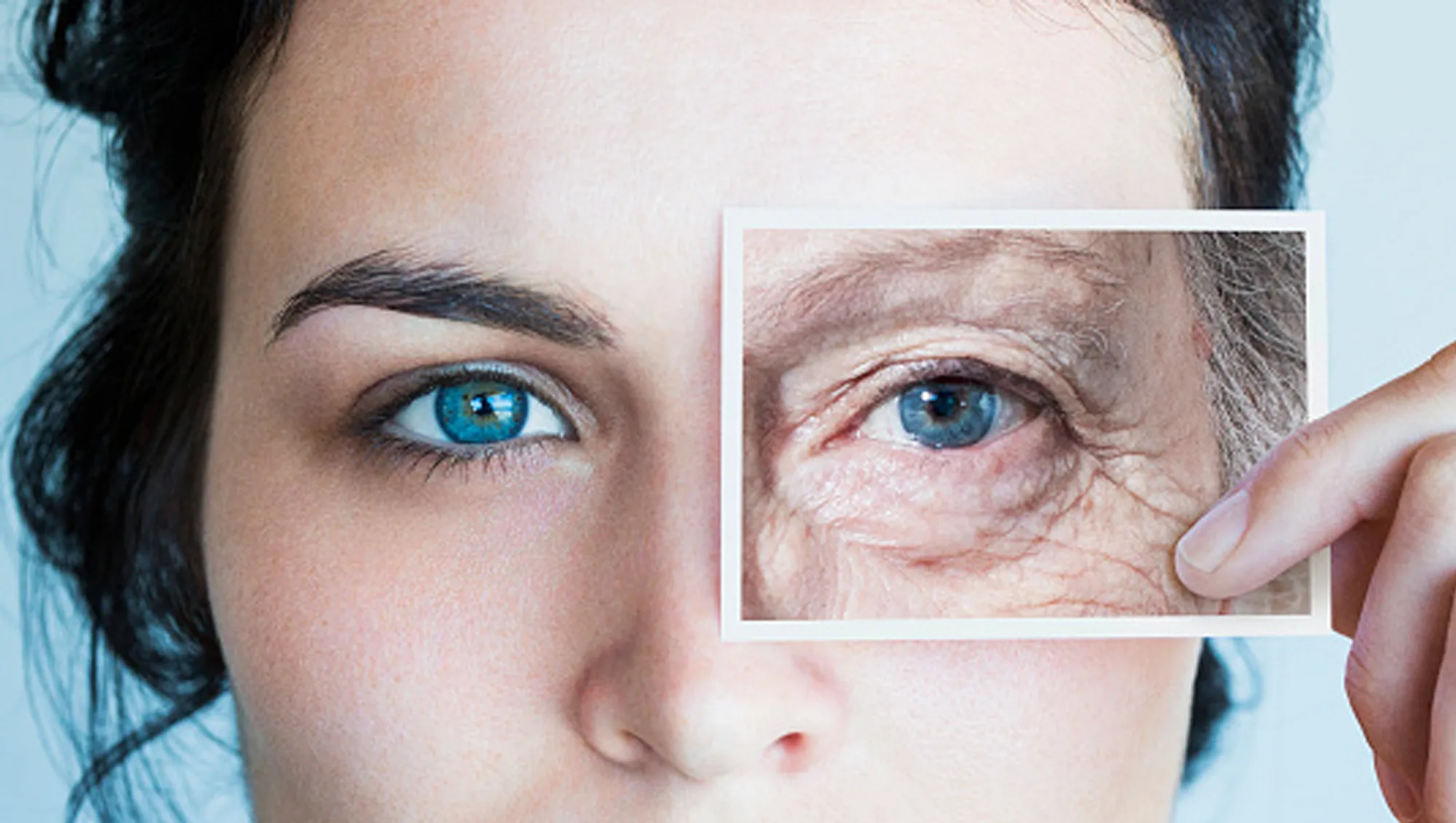 woman holding up aged eye picture