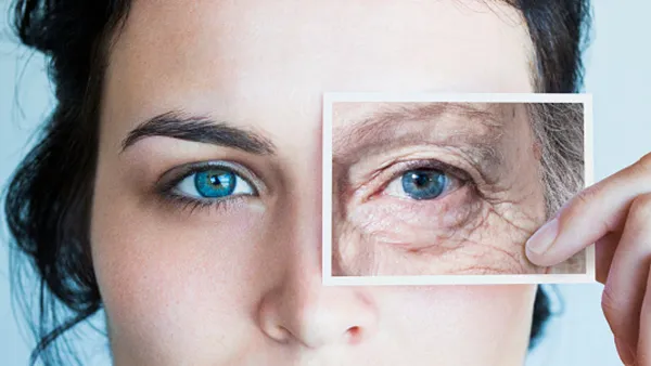 woman holding up aged eye picture
