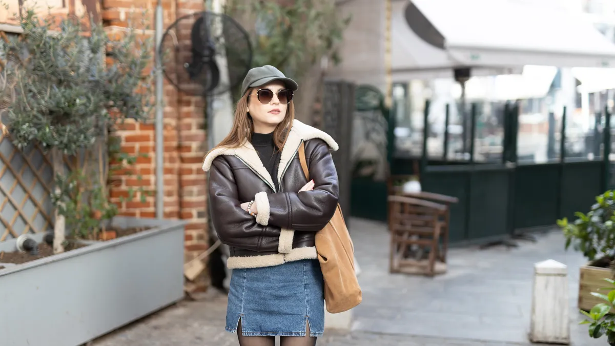 Portrait of a beautiful young fashionable woman wearing a cap.