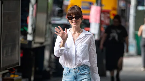 Dakota Johnson in white top and jeans