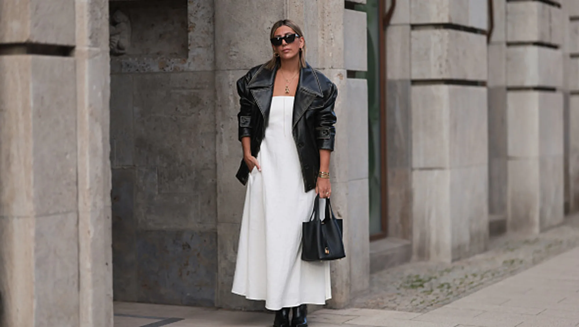 woman wearing white fall dress with black coat