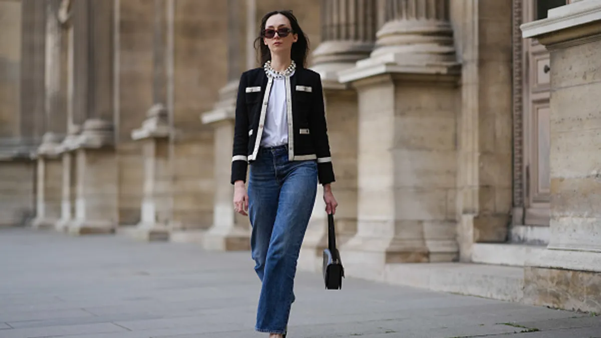 woman wearing chic black and white jacket and blue jeans